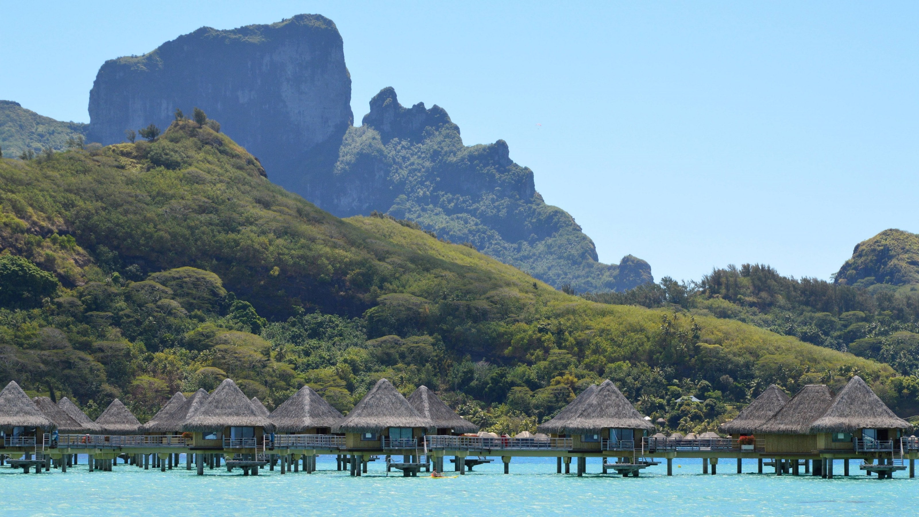 Overwater bungalows beneath Bora Bora's peaks