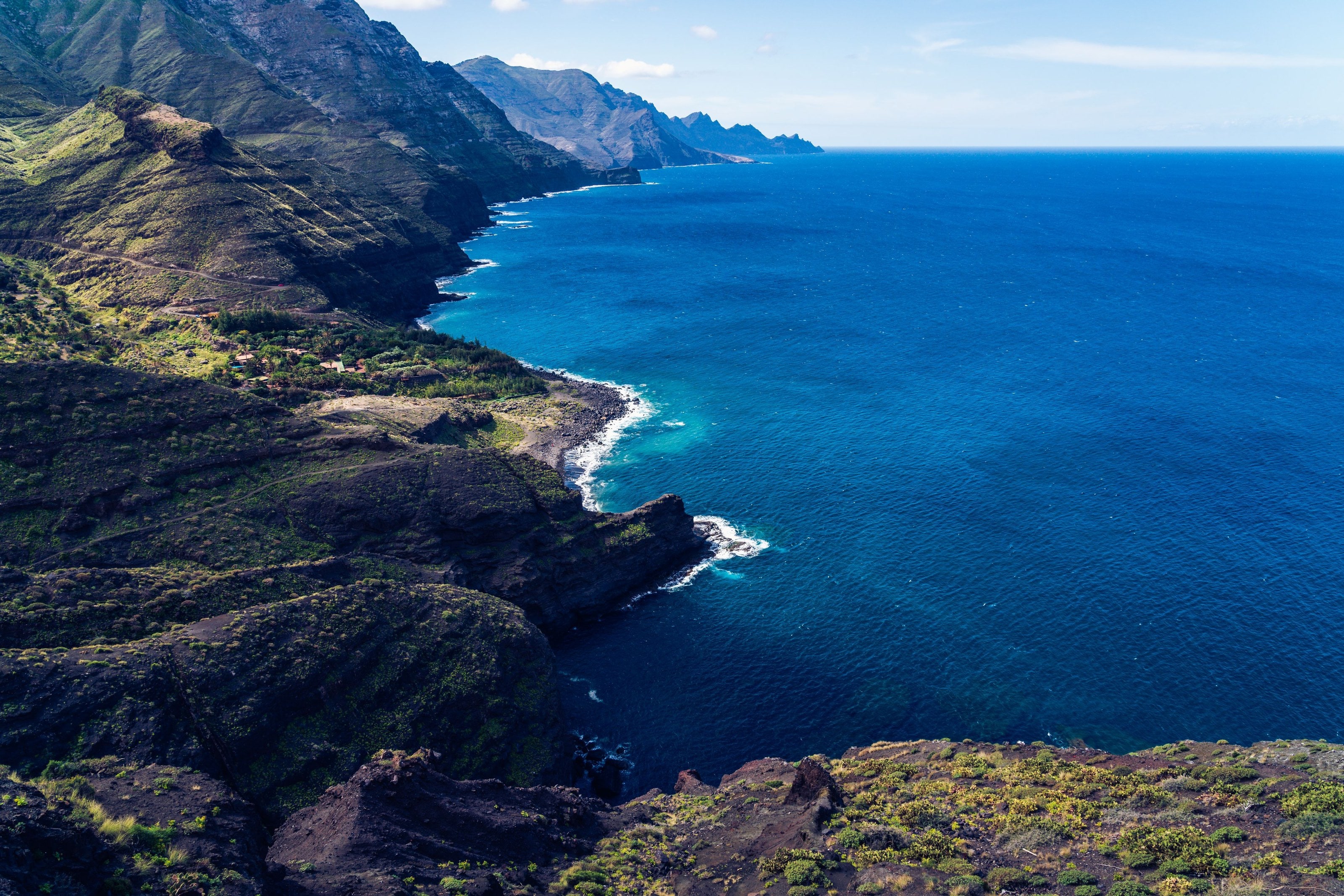 Volcanic coastline and deep blue water